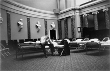 A senator rests on a cot in the Old Senate Chamber during a filibuster