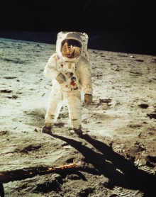 An astronaut standing on the surface of the moon