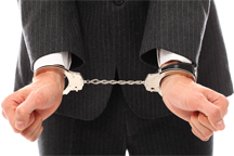 A businessman in handcuffs. Photo by RACOOL from FreeRangeStock.com