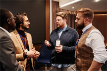 Men in conversation at an event