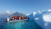 Ecotourists visit an iceberg off Greenland
