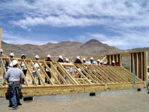 A team raises a wall of a new home sponsored by the U.S. Department of Housing and Urban Development