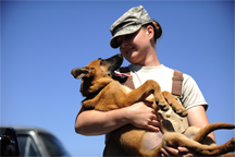 U.S. Air Force Staff Sgt. Christa Quam holds her puppy
