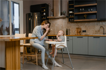 Mother feeding a child breakfast
