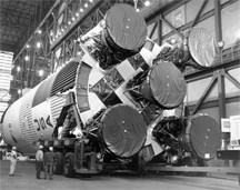 Workers prepare the S-IC first stage in the transfer aisle of the Vehicle Assembly Building at NASA's Kennedy Space Center