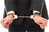 A businessman in handcuffs. Photo by RACOOL from FreeRangeStock.com