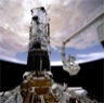 Astronauts Musgrave and Hoffman install corrective optics during the Hubble Telescope's Service Mission 1
