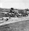 Soldiers of IX Engineering Command, U.S. Army Air Force, putting down a Pierced Steel Planking (PSP) Runway at an Advanced Landing Ground under construction somewhere in France following the Normandy Landings of World War II