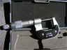 A micrometer capable of measuring to ± .01 mm