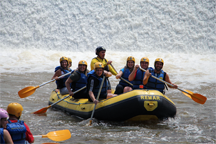 A white water rafting team completes its course